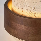 Layered travertine ceiling fixture with the light aperture glowing warm