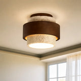 Cylindrical travertine ceiling light showing textured stone surface and warm glow