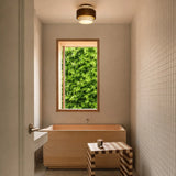 Close view of dark walnut wood tier on the travertine flush mount light