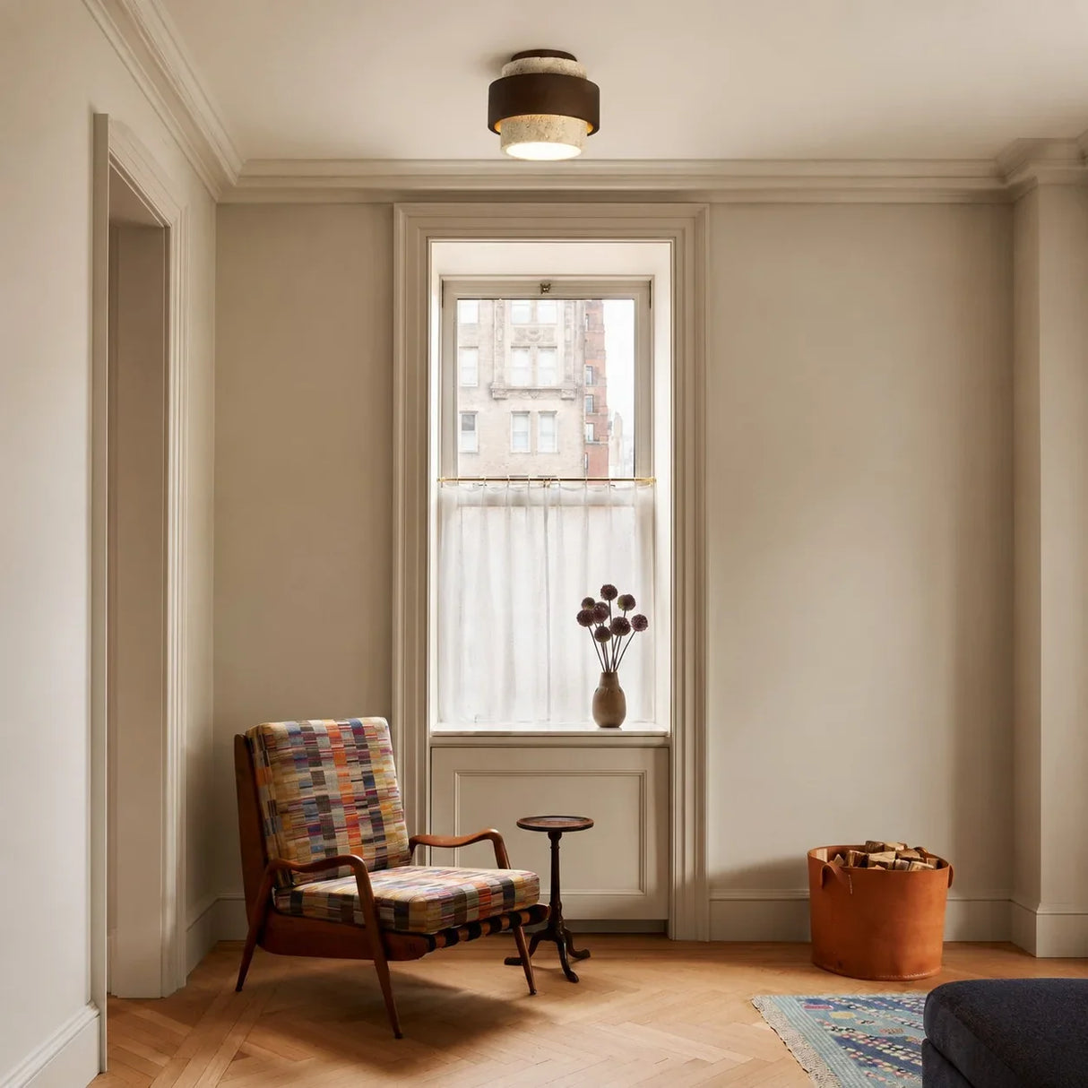 Travertine ceiling light illuminated to show warm ambient stone glow