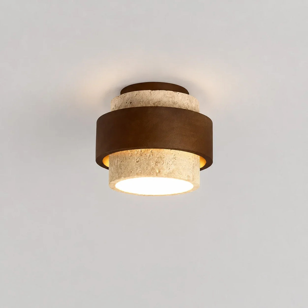 Cylindrical travertine and wood ceiling fixture photographed from above angle