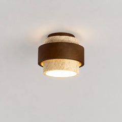 Cylindrical travertine and wood ceiling fixture photographed from above angle