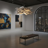 Large paper pendant shade lit in an open gallery space with dark artwork
