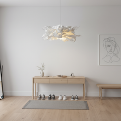 Paper pendant light above a slim console table in a plain white hallway
