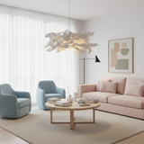 Paper pendant light in a bright living room with blue and pink armchairs