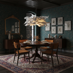 Paper pendant light over a round table in a dark green panelled dining room
