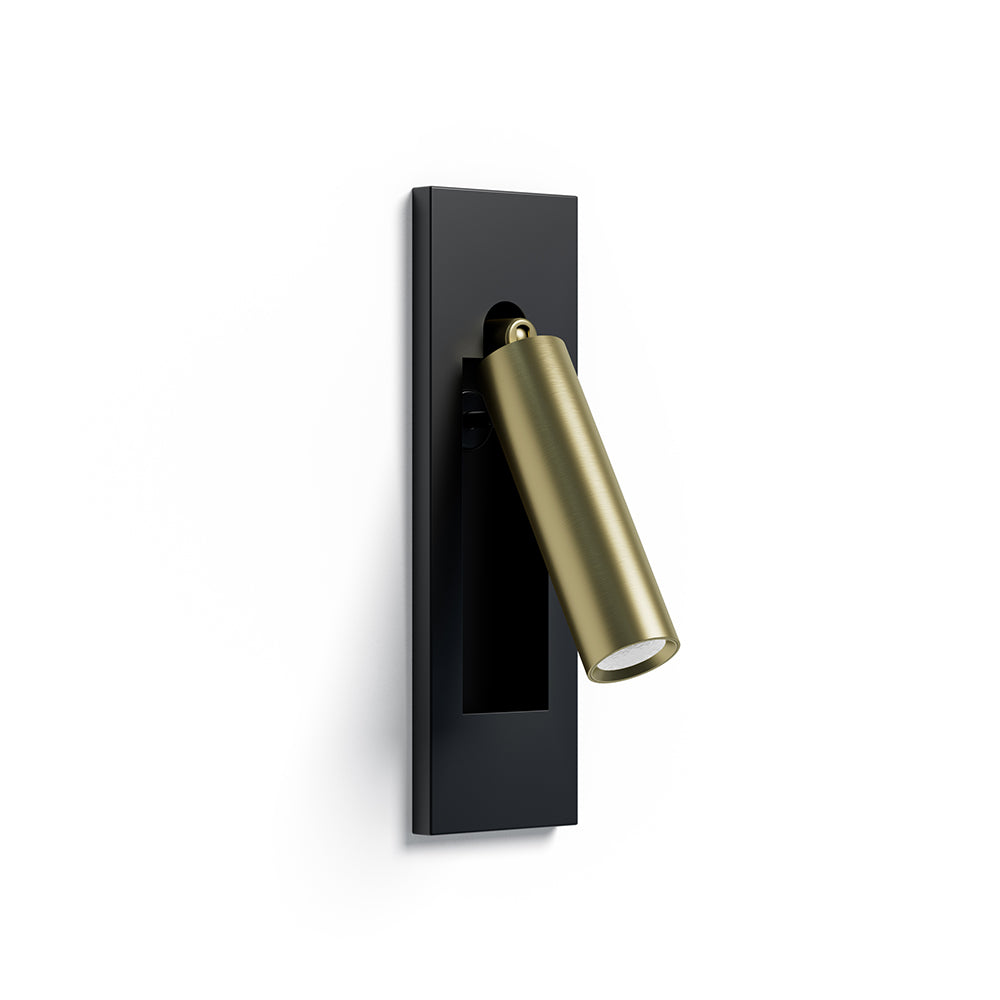 Wall mounted reading light with rotating head in a warm lit bedroom