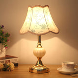 Gold base table lamp with embroidered daisy pattern fabric shade
