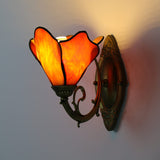 Wall sconce petal shade detail showing dark solder lines and glass panels