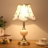 Gold base glass table lamp with purple floral fabric shade