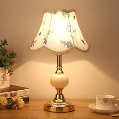 Gold base glass table lamp with purple floral fabric shade
