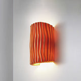 Orange striped half cylinder wall sconce with up and down glow