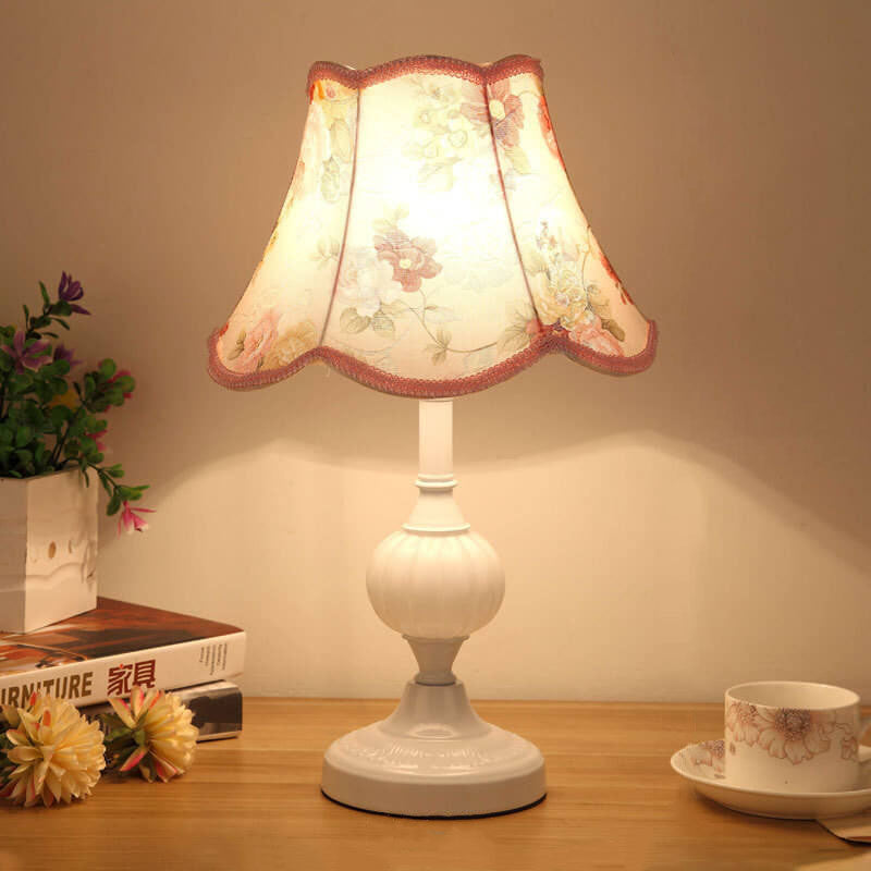 Gold base glass table lamp with cream pleated shade and plant