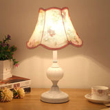 Gold base glass table lamp with cream pleated shade and plant