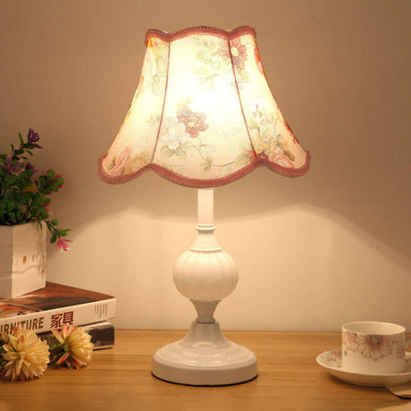 Gold base glass table lamp with cream pleated shade and plant