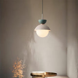 Scandinavian macaron pendant light lit against a soft neutral wall