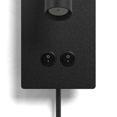 Wall light head angled up toward a headboard reading position