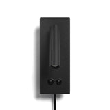 Matte black reading wall light against a neutral backdrop