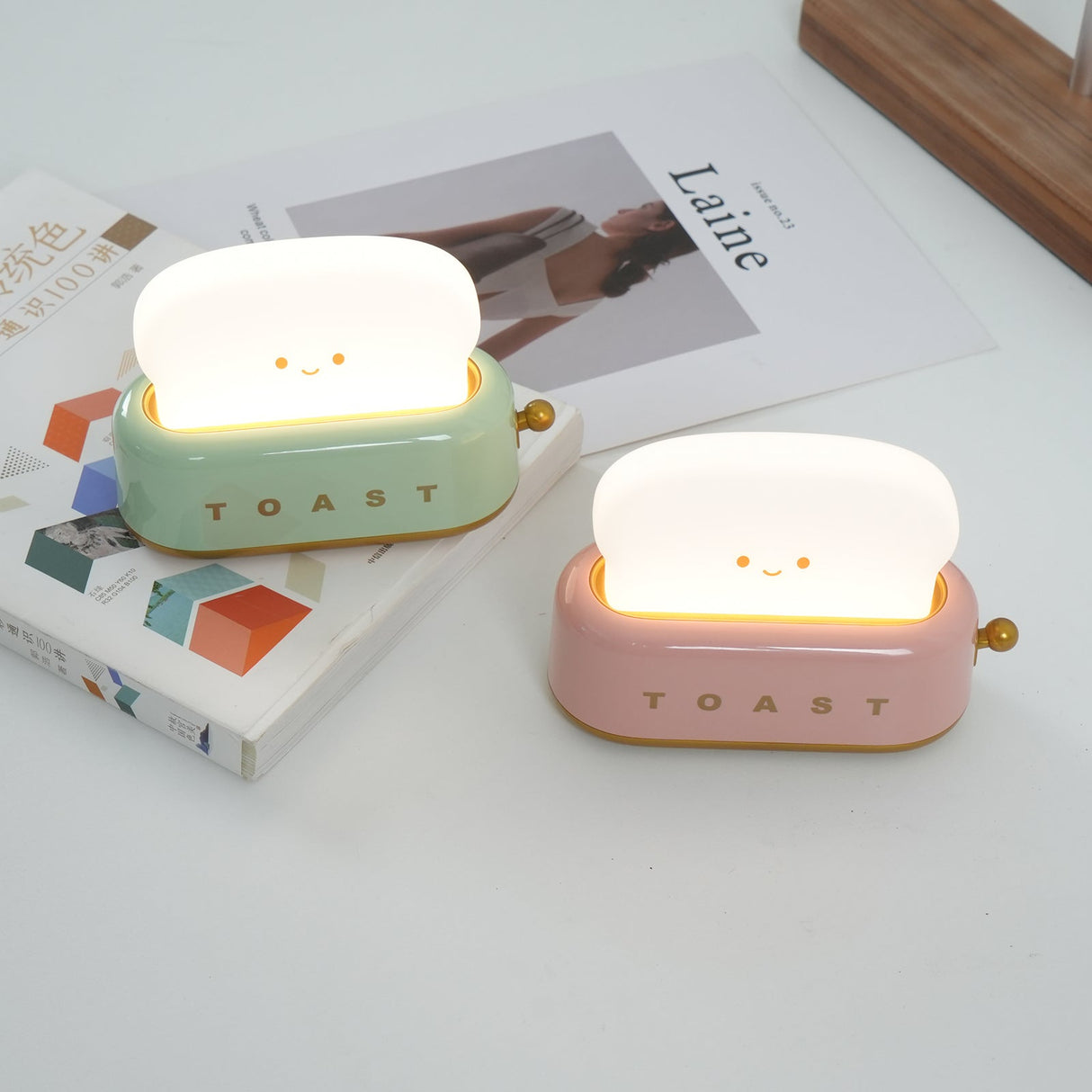 Toaster table lamp glowing warm on a bookshelf