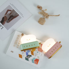 Small novelty toaster lamp beside a coffee mug