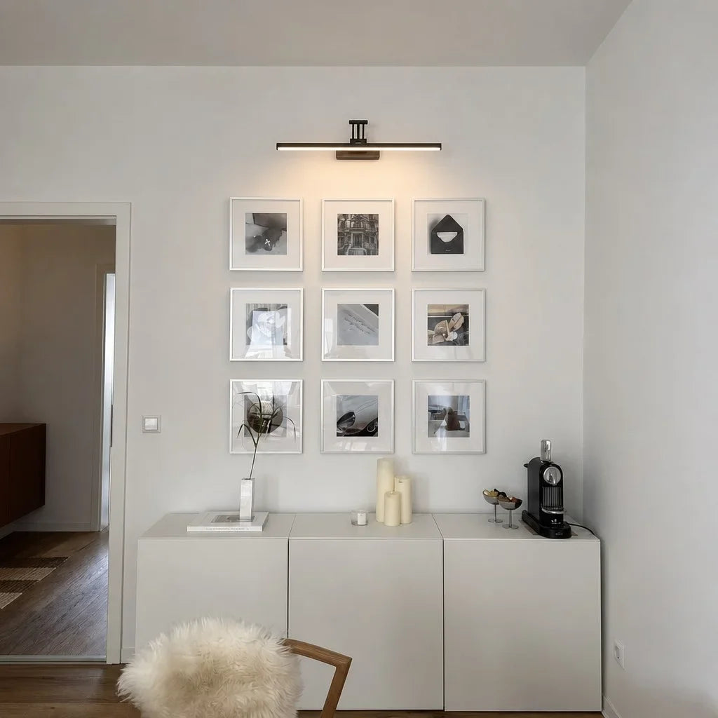 Modern integrated LED vanity light angled on its pivoting wall bracket