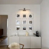 Modern integrated LED vanity light angled on its pivoting wall bracket