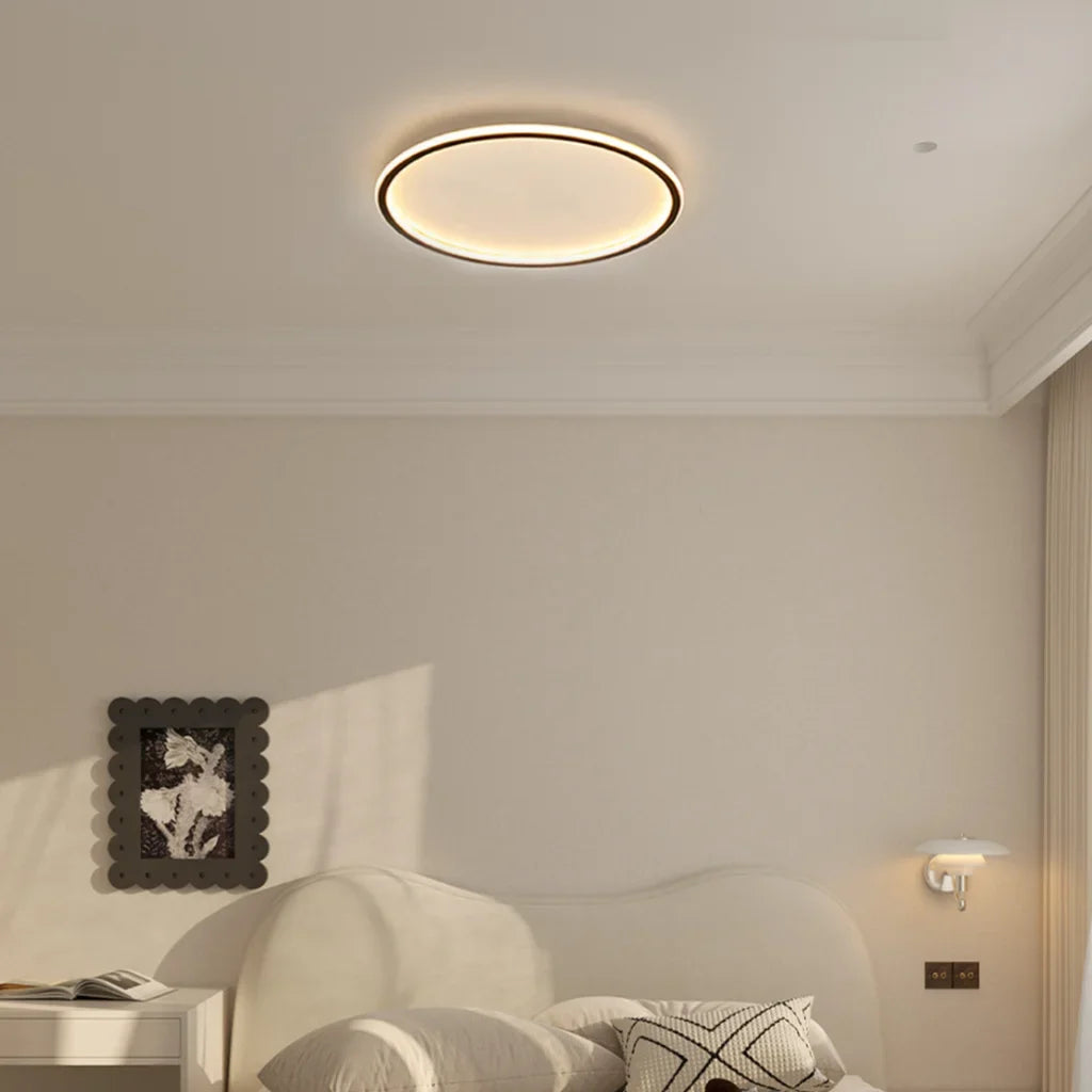 White round ceiling light close up showing slim metal ring frame