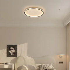 White round ceiling light close up showing slim metal ring frame