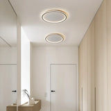 White round ceiling light glowing softly in a neutral room