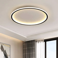 Black round LED flush mount ceiling light close up on ceiling