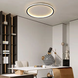 Black round ceiling light installed above a tidy home office room
