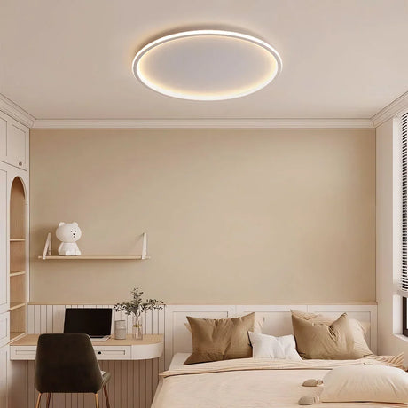 White round ceiling light illuminating a modern minimalist bedroom