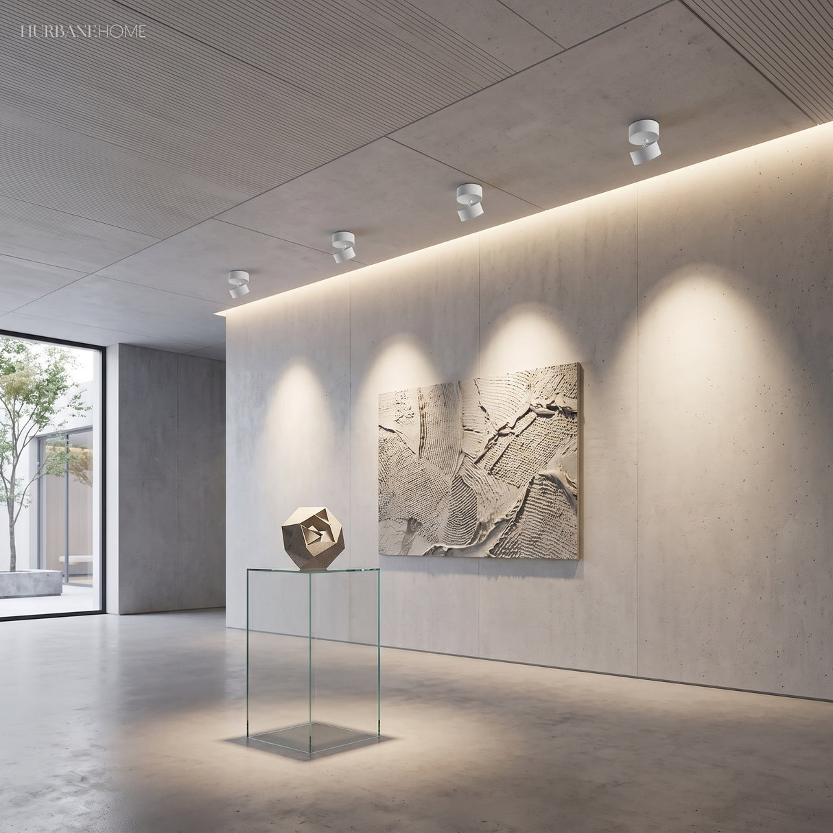 Row of surface mounted spot lights washing a textured stone artwork on a wall