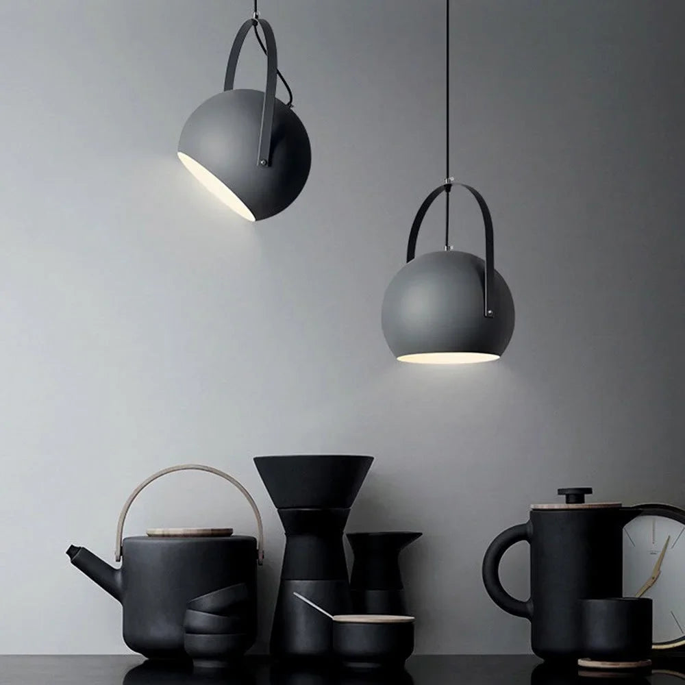 Blue ball pendant light tilted downward to show its lit open face