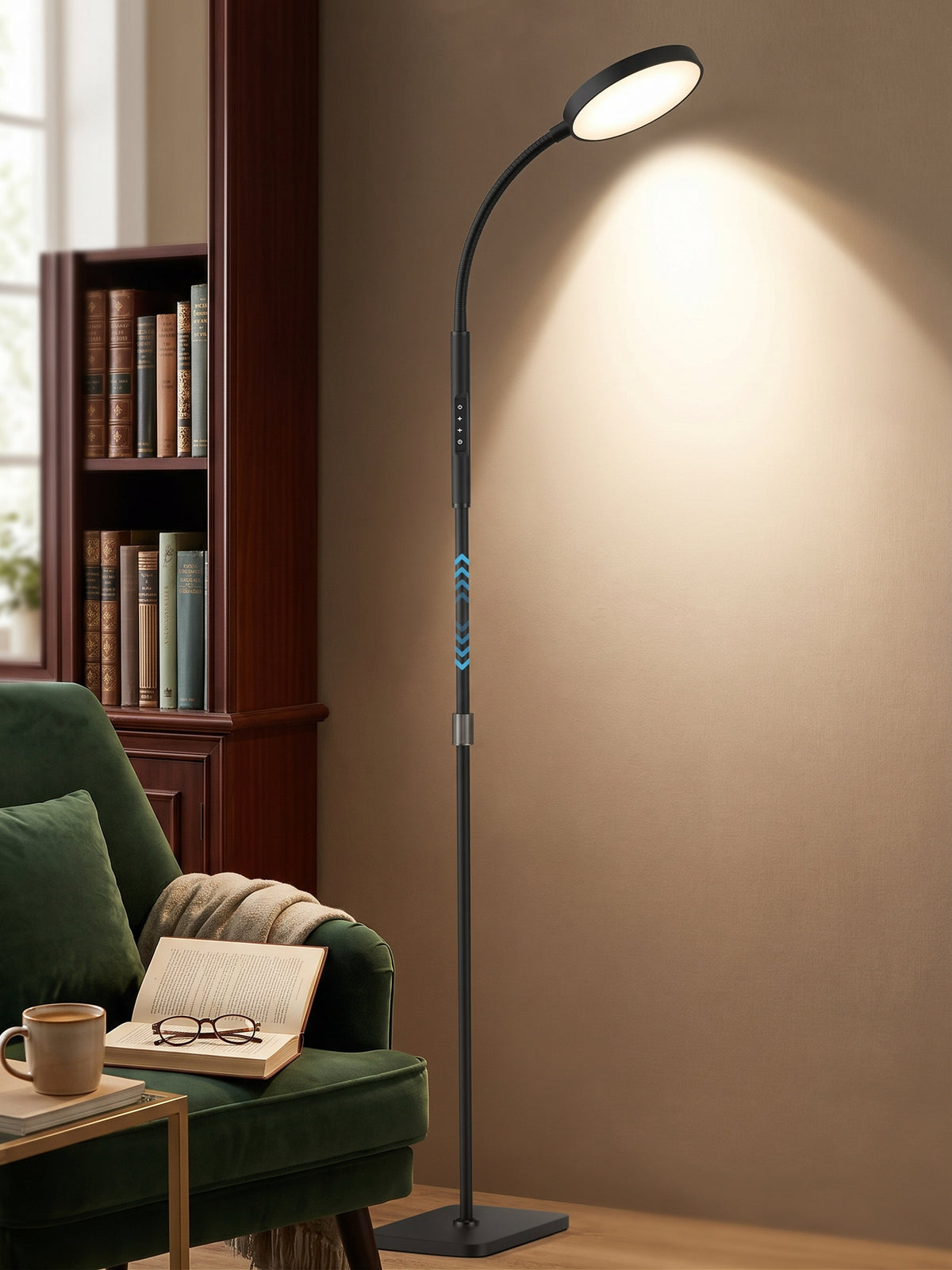 Adjustable LED reading floor lamp lighting a green armchair in a cosy reading nook