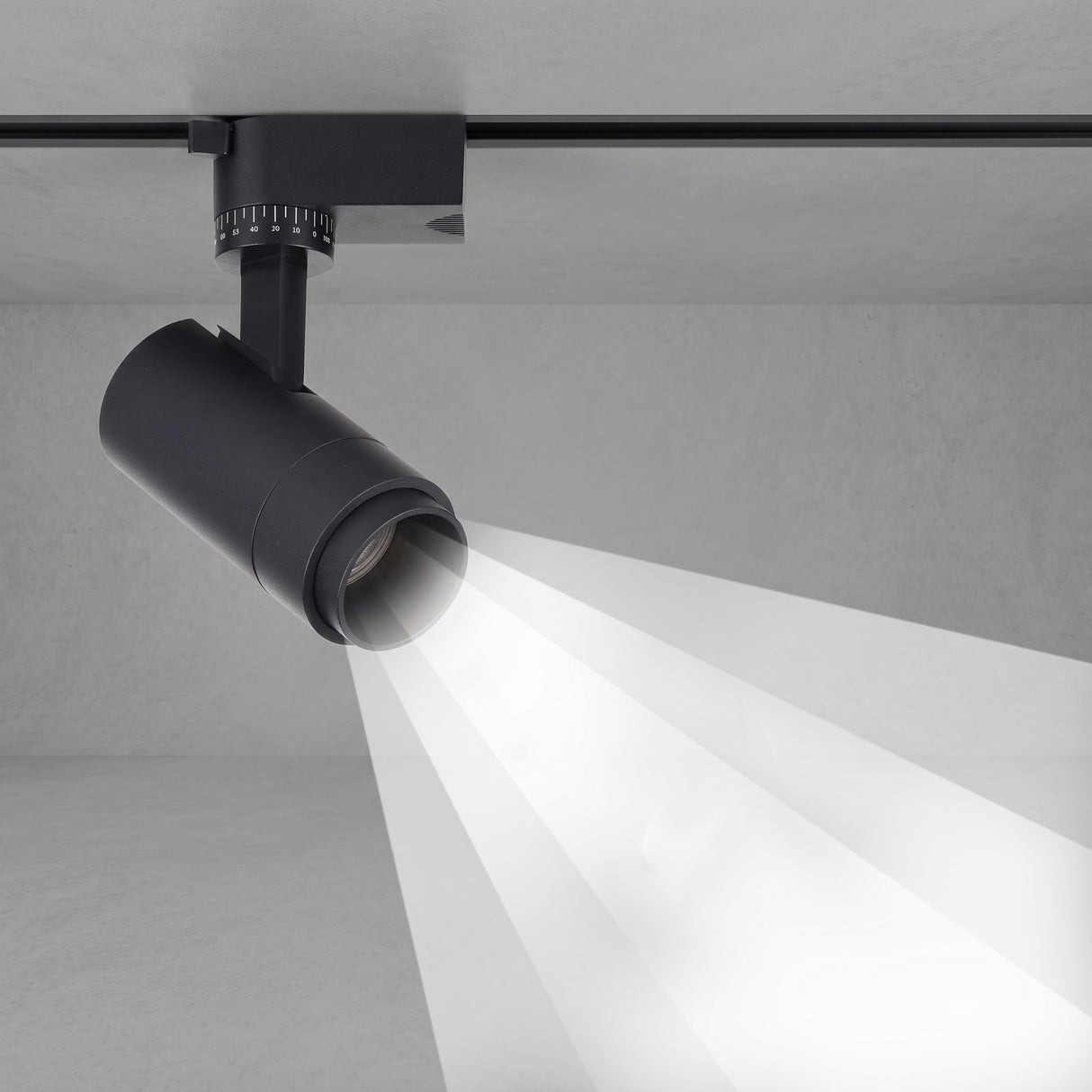 Black tubular track spotlight aimed down casting a focused beam