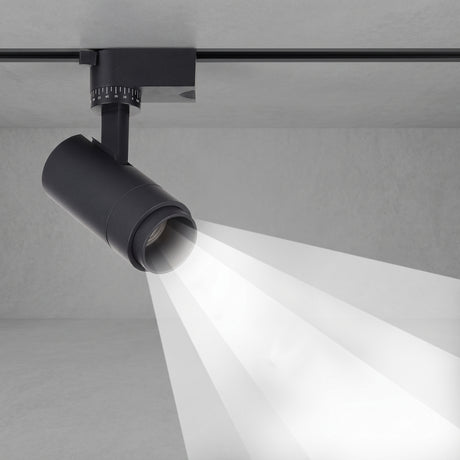 Black tubular track spotlight aimed down casting a focused beam
