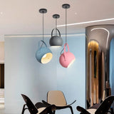 Adjustable metal ball pendant light presented on a plain studio backdrop