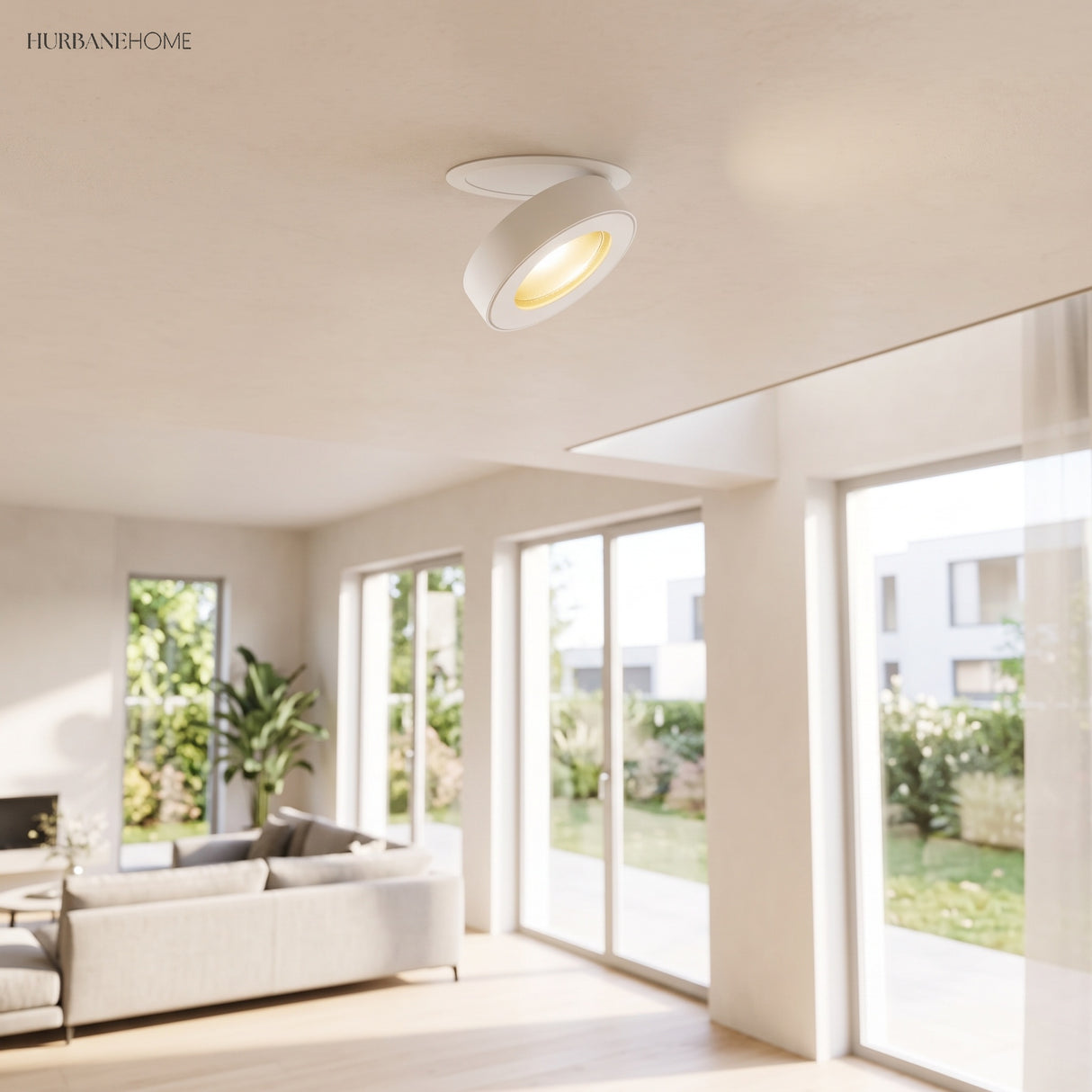 White rotatable downlight tilted from a ceiling in a bright open living room