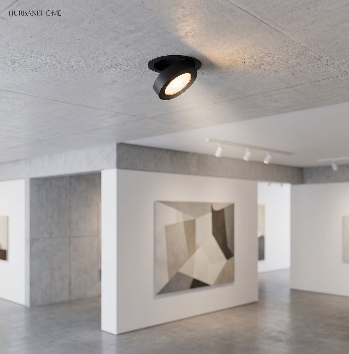 Black downlight angled out of a concrete ceiling in a white gallery space