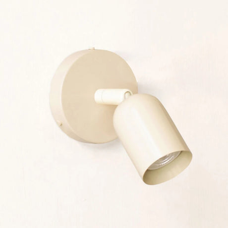 Beige spotlight wall sconce angled view with the head turned down and right