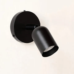 Black spotlight wall sconce angled view with the head turned down and right