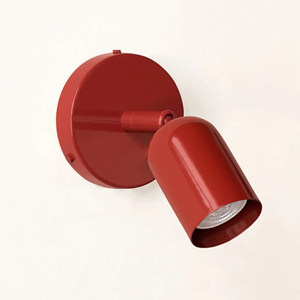 Red spotlight wall sconce angled view with the shade turned away from the wall