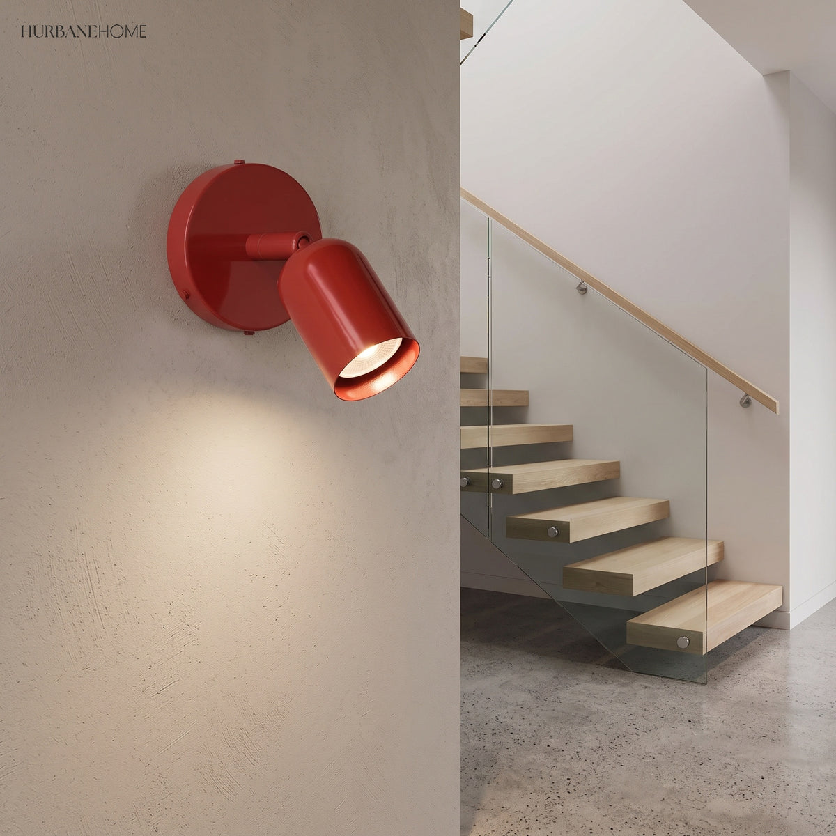 Red spotlight wall sconce on a textured wall beside a staircase landing