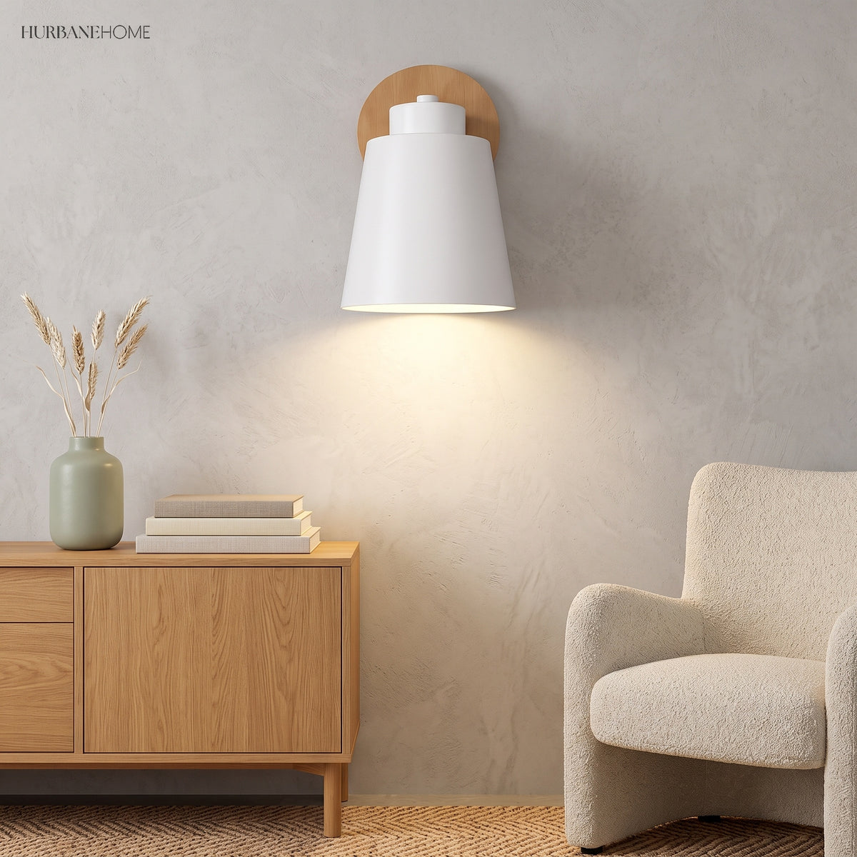 White sconce lit on a plain wall above an oak sideboard
