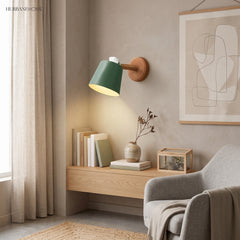 Green sconce lit above a timber shelf and reading chair