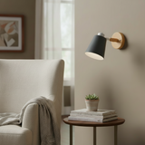 Grey sconce shown in profile with the swivel joint visible