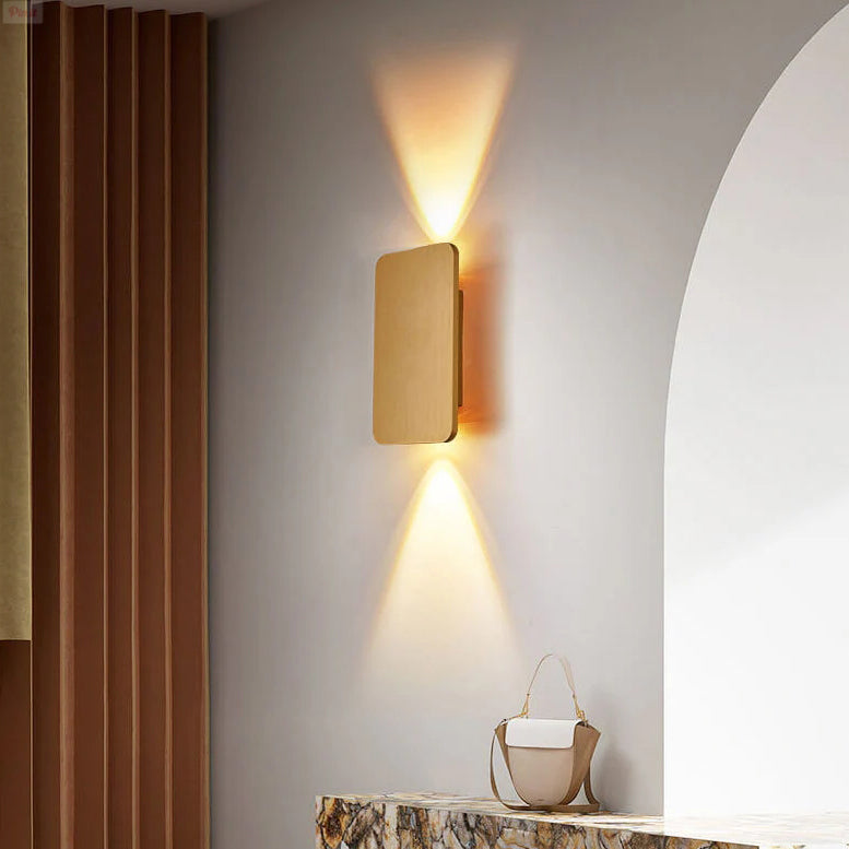 Rectangular wall sconce lit to show its upward and downward beams