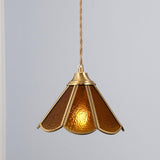 Amber glass pendant shown alone with the textured panels lit from inside