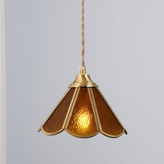 Amber glass pendant shown alone with the textured panels lit from inside